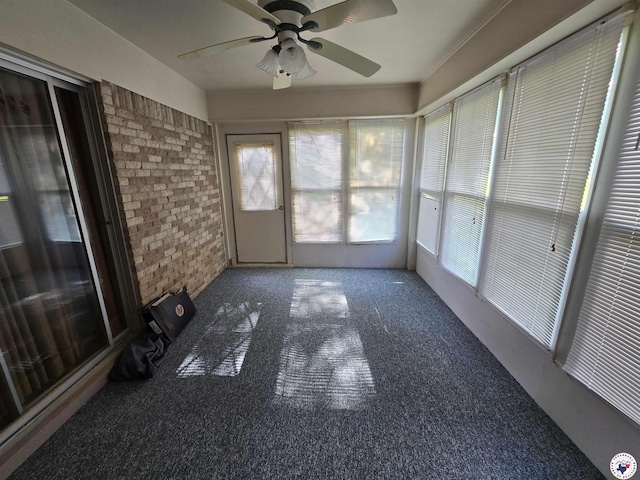 123 Texas Ln, New Boston, TX 75570 - unfurnished sunroom featuring brick wall, a ceiling fan, and healthy amount of natural light