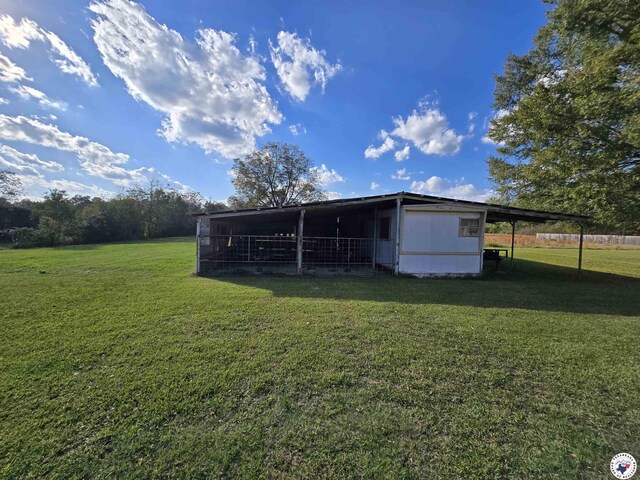 123 Texas Ln, New Boston, TX 75570 - back of house featuring a lawn, an outbuilding, and an outdoor structure