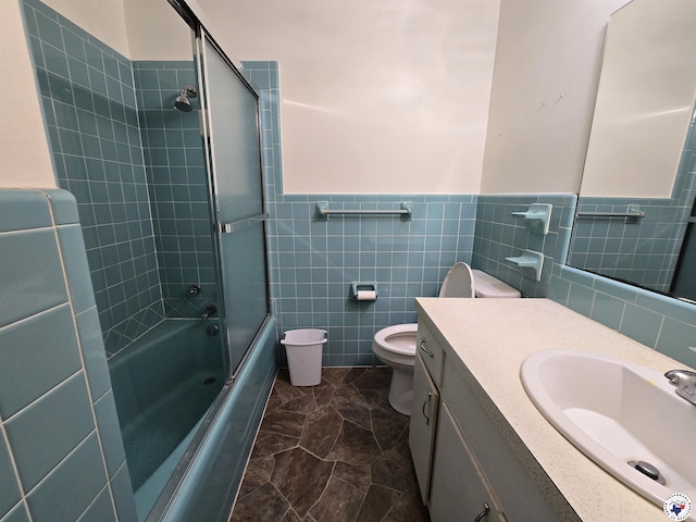 123 Texas Ln, New Boston, TX 75570 - full bathroom with toilet, vanity, tile walls, wainscoting, and shower / bath combination with glass door