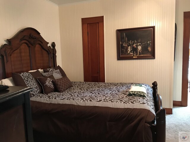 bedroom featuring crown molding and carpet floors