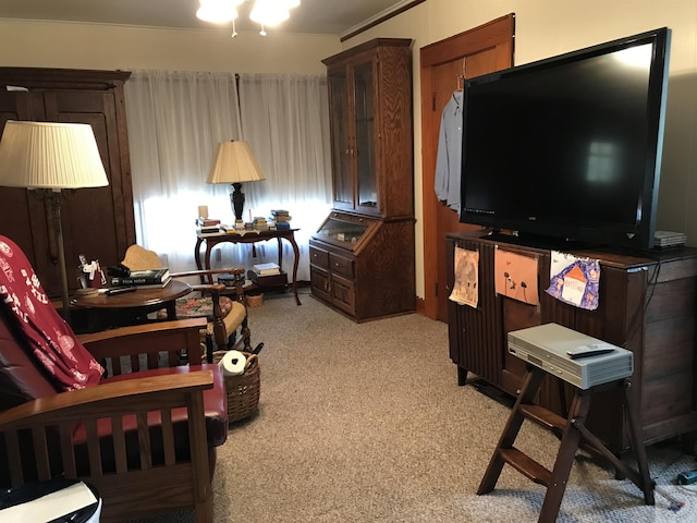 carpeted living room with ornamental molding