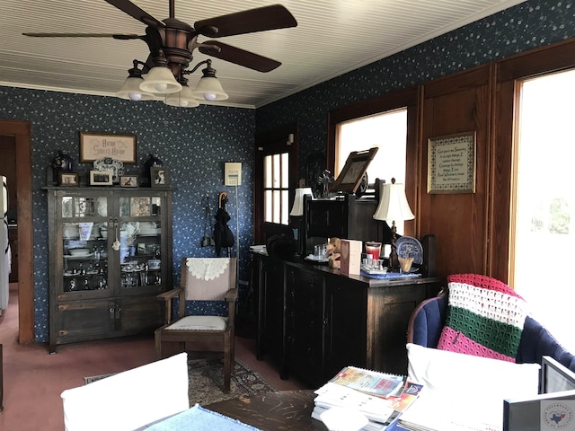 interior space with ceiling fan and crown molding