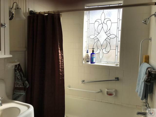 bathroom with shower / tub combo and plenty of natural light