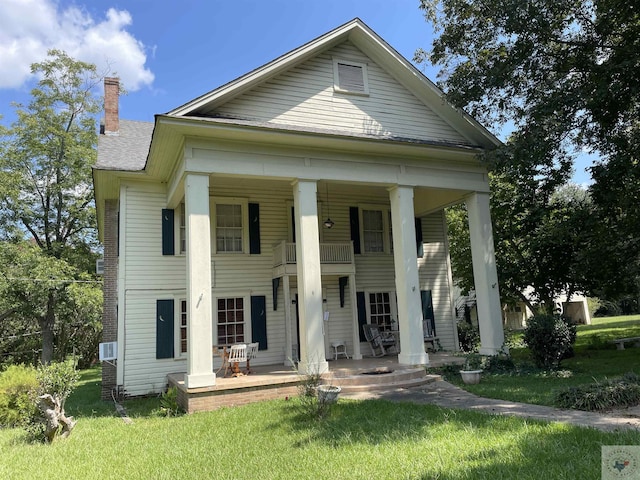 neoclassical / greek revival house with a balcony and a porch