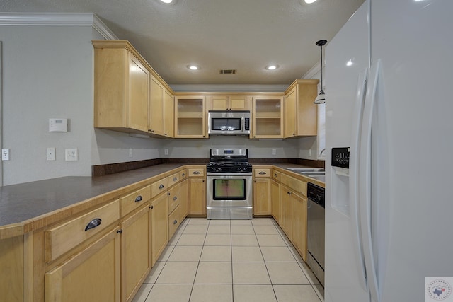 kitchen featuring dark countertops, light tile patterned floors, appliances with stainless steel finishes, and light brown cabinetry