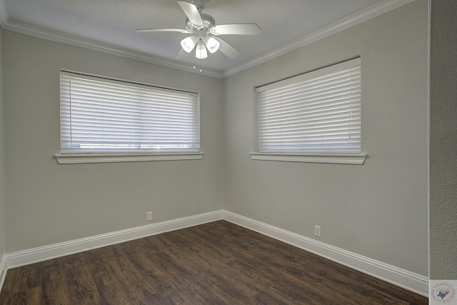 empty room with dark wood-style floors, ceiling fan, crown molding, and baseboards