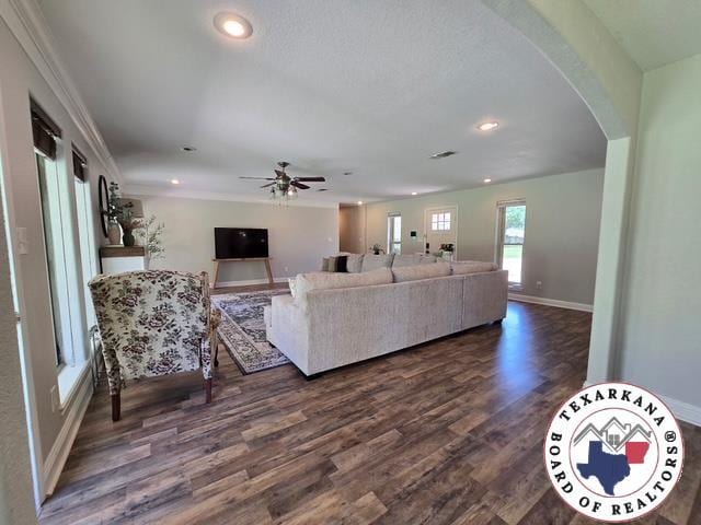 7 Summer Ln, Texarkana, TX 75503 - living room featuring dark wood-style flooring, arched walkways, recessed lighting, baseboards, and a ceiling fan