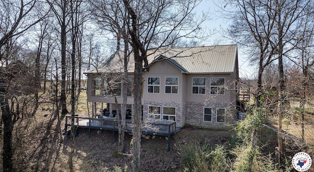 exterior space featuring a wooden deck and a sunroom