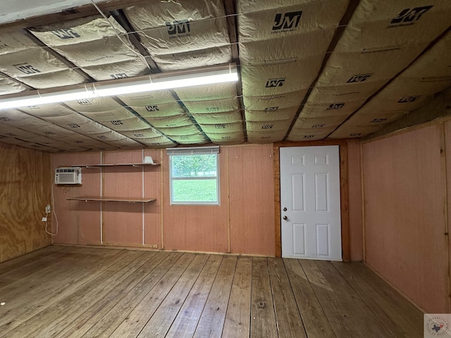 unfinished attic with an AC wall unit