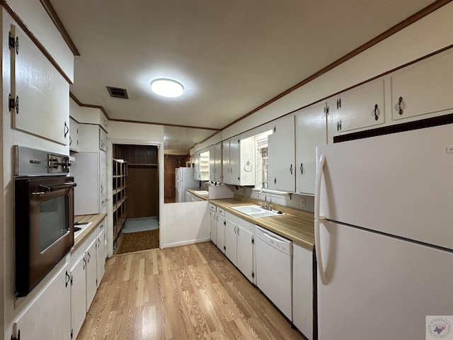 kitchen featuring sink, white cabinetry, white appliances, ornamental molding, and light hardwood / wood-style floors