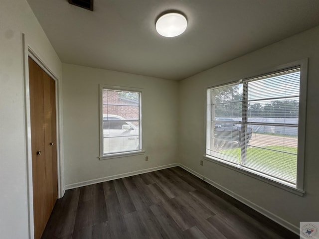 spare room featuring dark hardwood / wood-style flooring