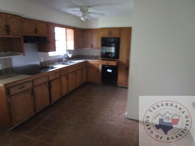 kitchen with black appliances, ceiling fan, extractor fan, and sink