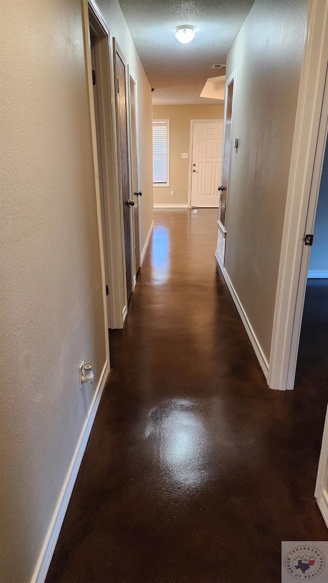 corridor with a textured ceiling