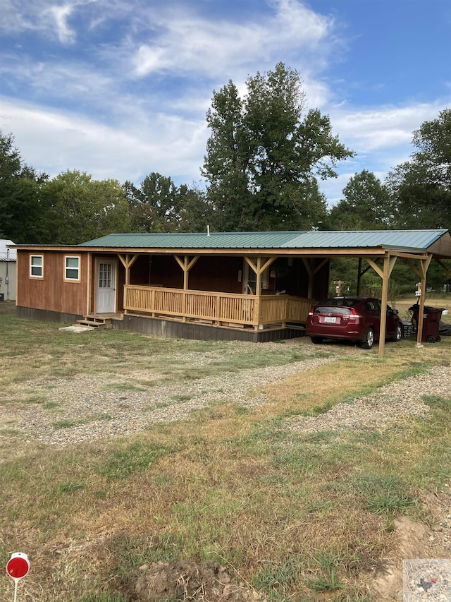 exterior space with a carport and a front lawn