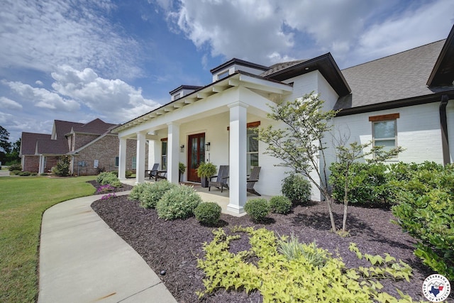 8203 Teal Rd, Texarkana, TX 75503 - view of property exterior featuring brick siding, a porch, a lawn, and a shingled roof