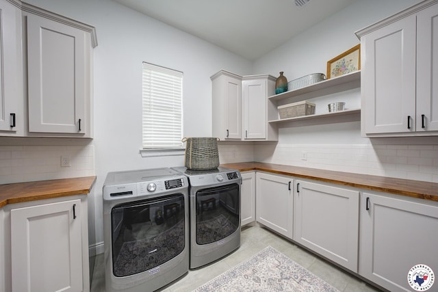 8203 Teal Rd, Texarkana, TX 75503 - washroom featuring washing machine and dryer, cabinet space, and light tile patterned floors