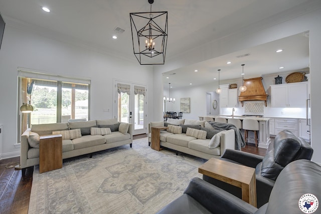 8203 Teal Rd, Texarkana, TX 75503 - living room with a chandelier, ornamental molding, wood finished floors, recessed lighting, and french doors