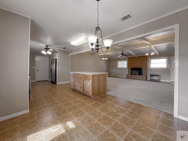 kitchen with light carpet, beam ceiling, a tile fireplace, ceiling fan with notable chandelier, and stainless steel refrigerator