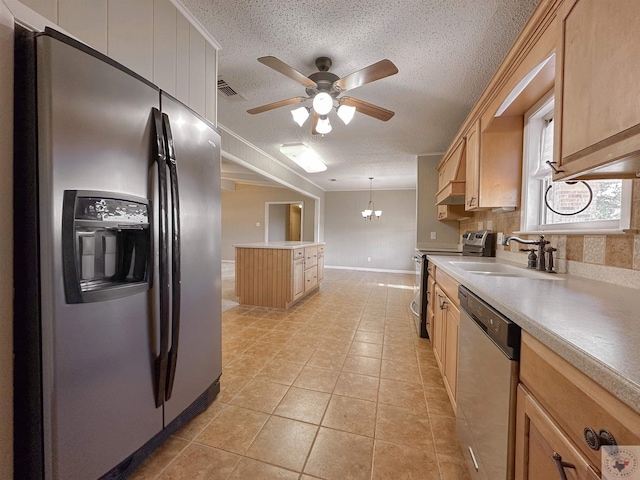 kitchen with appliances with stainless steel finishes, light tile patterned floors, sink, pendant lighting, and light brown cabinets