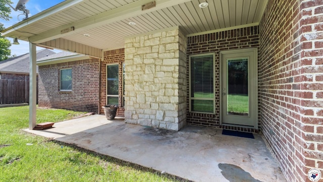 5005 Hidden Acres Dr, Texarkana, TX 75503 - doorway to property featuring brick siding and a patio