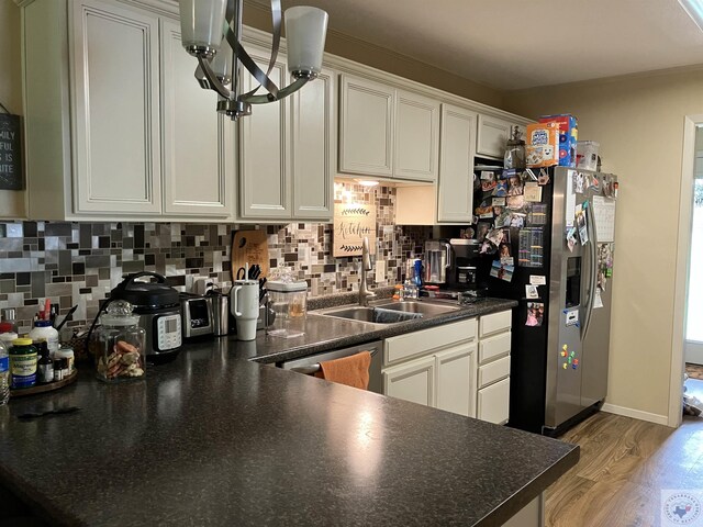 1407 County Road 4114, Atlanta, TX 75551 - kitchen with stainless steel appliances, backsplash, white cabinetry, and light hardwood / wood-style flooring