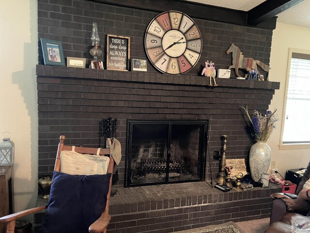 interior details featuring beamed ceiling and a fireplace