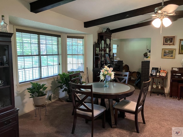 carpeted dining room featuring ceiling fan and lofted ceiling with beams