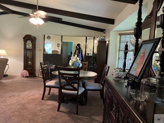 carpeted dining room with ceiling fan and vaulted ceiling with beams