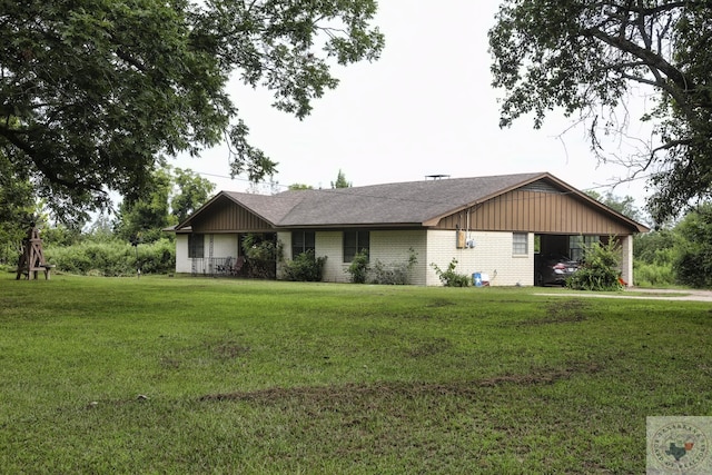 ranch-style home featuring a front lawn and a carport