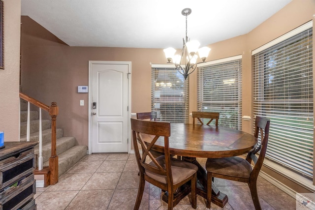 dining area featuring a chandelier and light tile patterned floors