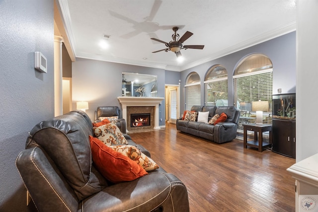 living room featuring ceiling fan, dark hardwood / wood-style flooring, and ornamental molding