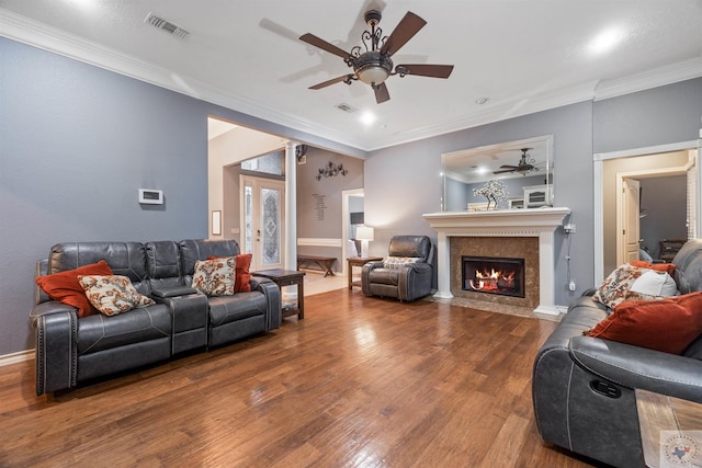 living room with hardwood / wood-style flooring, ornamental molding, and ceiling fan