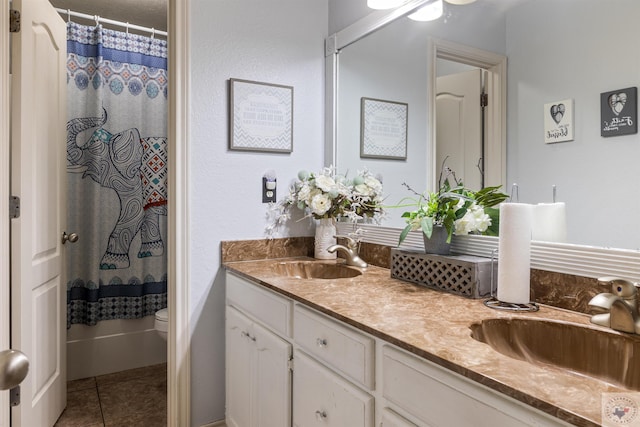 bathroom with vanity, toilet, tile patterned floors, and a shower with shower curtain