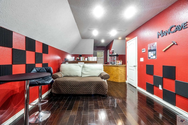 bedroom featuring a textured ceiling and lofted ceiling