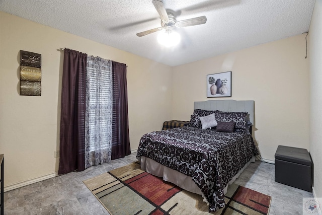 bedroom with ceiling fan and a textured ceiling