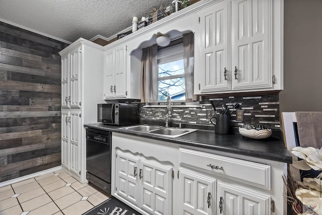 kitchen with sink, white cabinetry, wooden walls, black appliances, and a textured ceiling