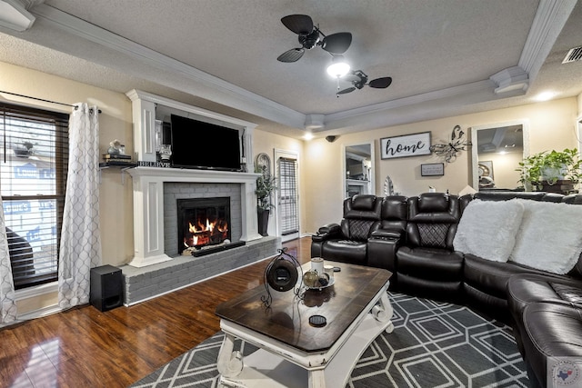 interior space with dark wood-type flooring, a fireplace, a textured ceiling, and crown molding