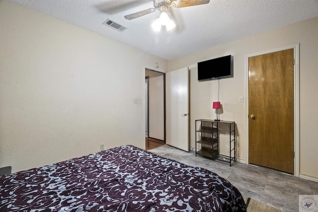 bedroom with a textured ceiling and ceiling fan