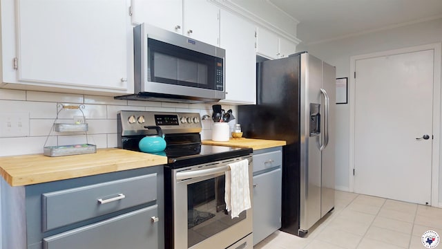5500 Pleasant Grove Rd, Texarkana, TX 75503 - kitchen featuring stainless steel appliances, butcher block counters, crown molding, tasteful backsplash, and white cabinetry
