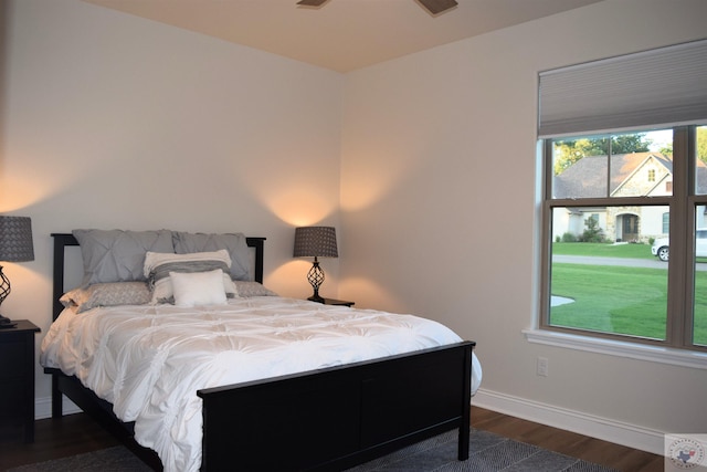 bedroom with dark hardwood / wood-style flooring