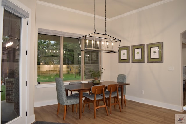 dining room with wood-type flooring and ornamental molding