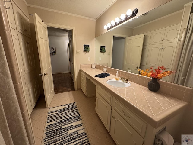 bathroom featuring a textured ceiling, vanity, and ornamental molding