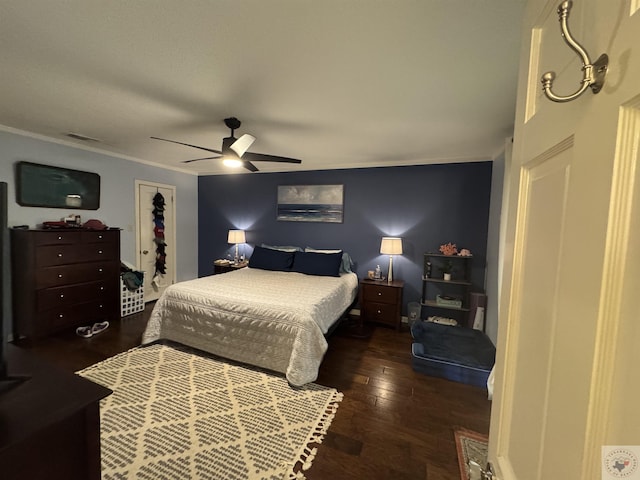 bedroom featuring ceiling fan, ornamental molding, and dark hardwood / wood-style flooring