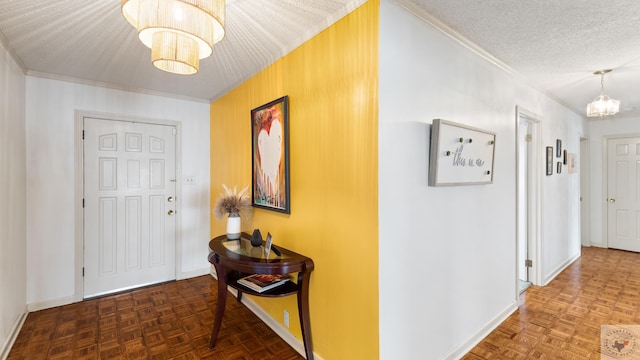 foyer featuring baseboards, a notable chandelier, crown molding, and a textured ceiling