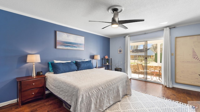 bedroom featuring a textured ceiling, wood finished floors, baseboards, and access to outside