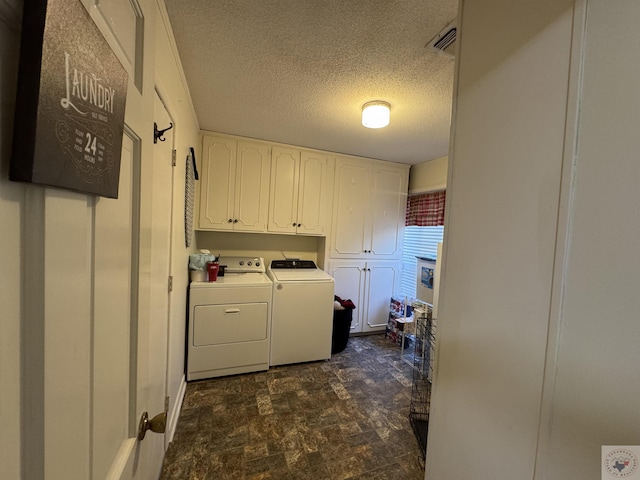 washroom with cabinets, separate washer and dryer, and a textured ceiling