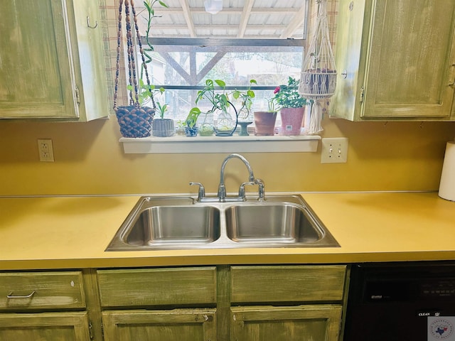 kitchen with a sink, light countertops, and dishwasher