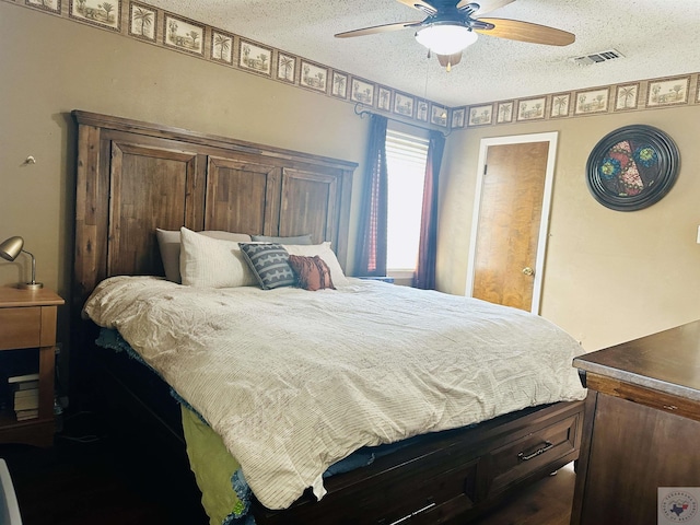 bedroom with ceiling fan, visible vents, and a textured ceiling