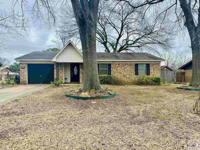 ranch-style home with driveway, brick siding, and an attached garage