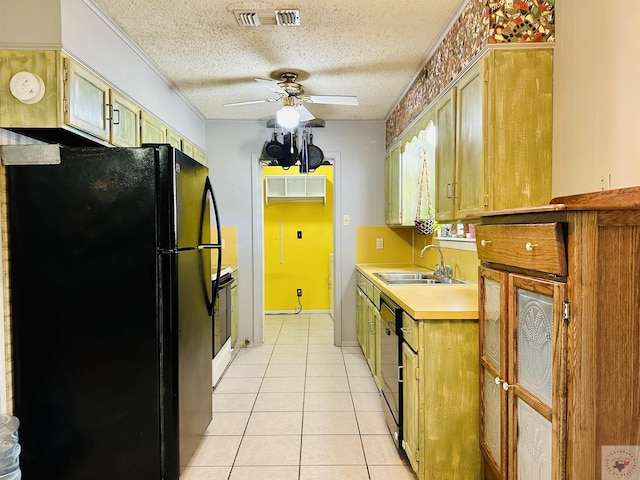 kitchen with light tile patterned floors, light countertops, visible vents, a sink, and black appliances